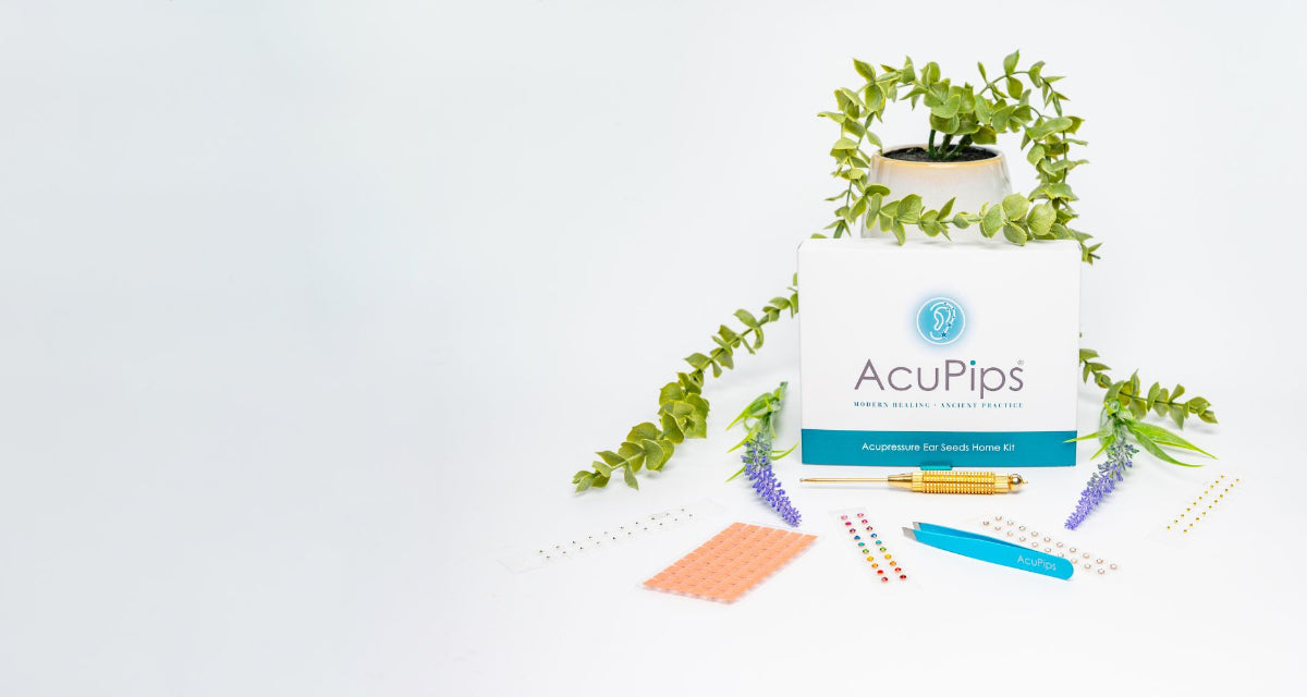 AcuPips product packaging with plants and stationery items on a light gray background