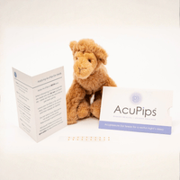Plush lion toy with AcuPips packaging and leaflet on a white background